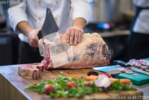 Image of chef cutting big piece of beef