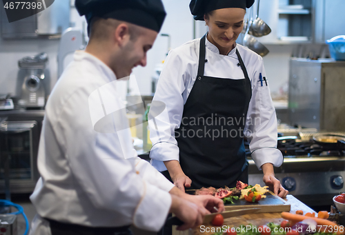 Image of team cooks and chefs preparing meal