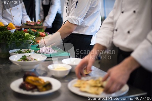 Image of team cooks and chefs preparing meal