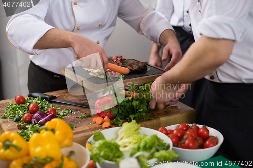 Image of team cooks and chefs preparing meal