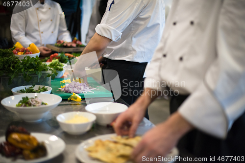 Image of team cooks and chefs preparing meal