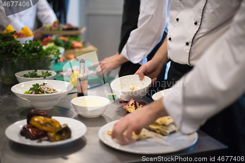 Image of team cooks and chefs preparing meal