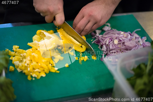 Image of Chef hands cutting fresh and delicious vegetables