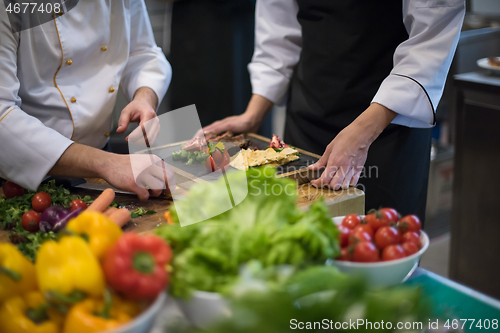 Image of team cooks and chefs preparing meal