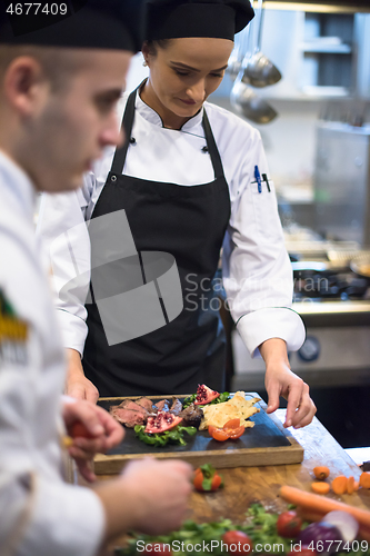 Image of team cooks and chefs preparing meal