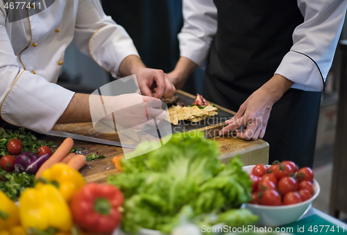 Image of team cooks and chefs preparing meal