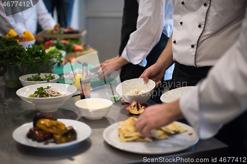 Image of team cooks and chefs preparing meal