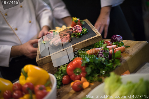 Image of team cooks and chefs preparing meal