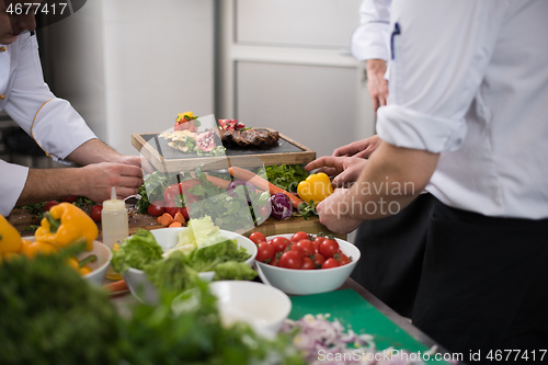Image of team cooks and chefs preparing meal
