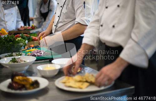 Image of team cooks and chefs preparing meal