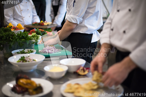 Image of team cooks and chefs preparing meal