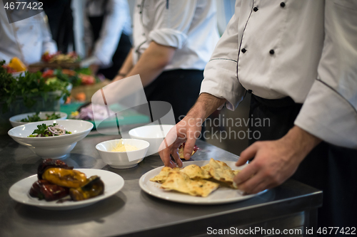 Image of team cooks and chefs preparing meal