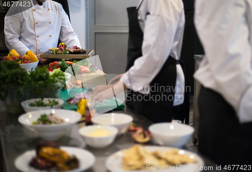 Image of team cooks and chefs preparing meal