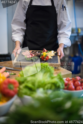 Image of female Chef holding beef steak plate