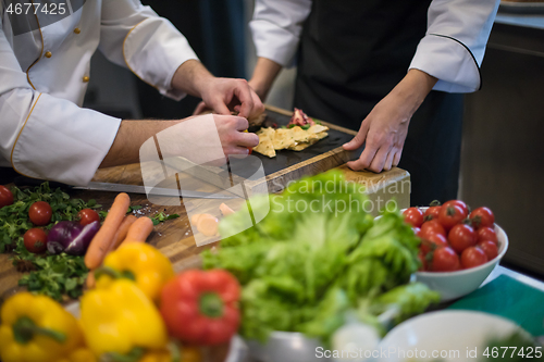 Image of team cooks and chefs preparing meal