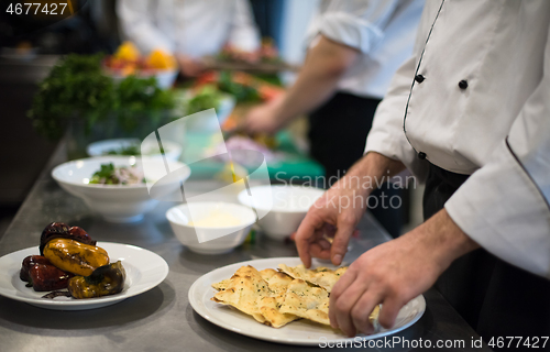 Image of team cooks and chefs preparing meal