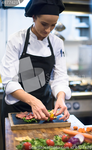 Image of female Chef preparing beef steak