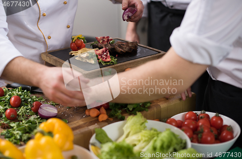 Image of team cooks and chefs preparing meal