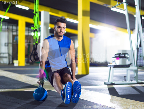 Image of Young strong man doing pushups