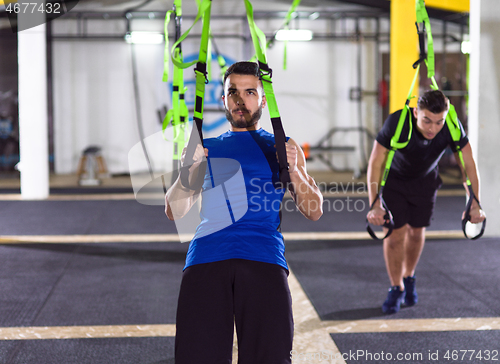 Image of men working out pull ups with gymnastic rings