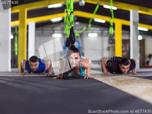 Image of young healthy people doing pushups