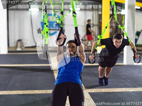 Image of men working out pull ups with gymnastic rings