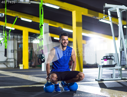 Image of Young strong man doing pushups