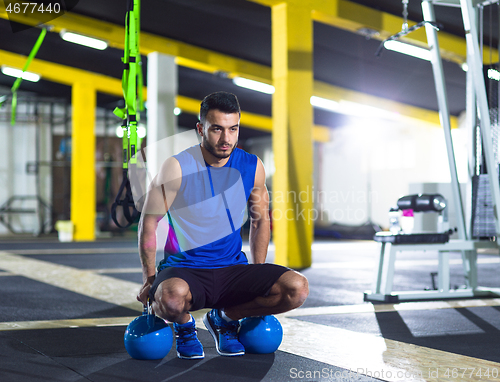 Image of Young strong man doing pushups