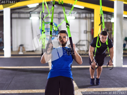 Image of men working out pull ups with gymnastic rings