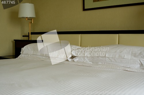 Image of King sized bed in a hotel suite room