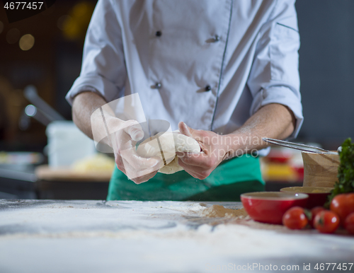 Image of chef hands preparing dough for pizza