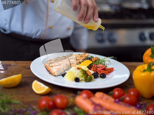 Image of Chef finishing steak meat plate