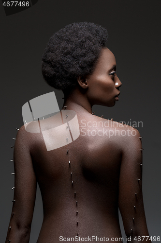 Image of Beautiful black girl with metal pins