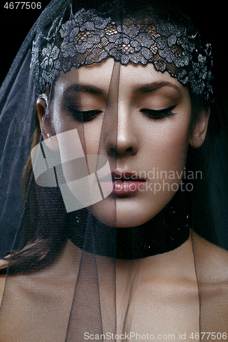 Image of Beautiful girl with black lace veil