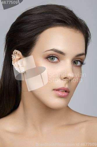 Image of Beautiful girl with pearls on ear