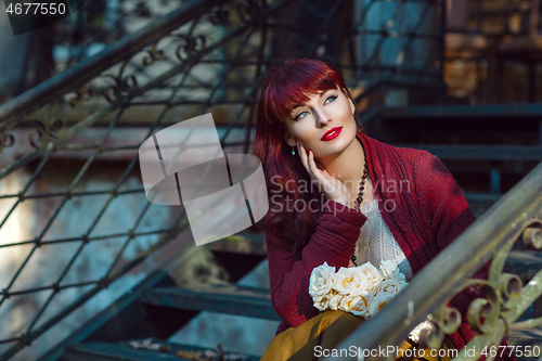 Image of Girl sitting on old house stairs