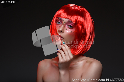 Image of Beautiful girl in red wig