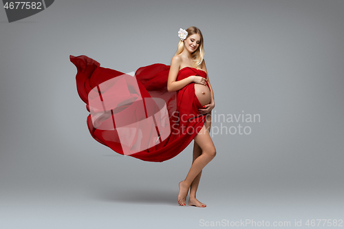 Image of Pregnant girl in red dress