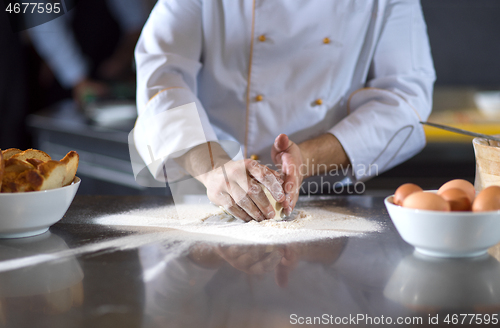 Image of chef hands preparing dough for pizza