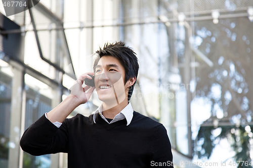 Image of Casual asian businessman on the phone