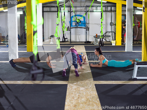 Image of young healthy people doing pushups