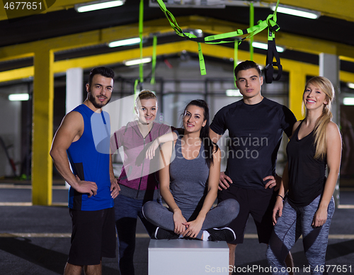 Image of portrait of athletes working out  jumping on fit box