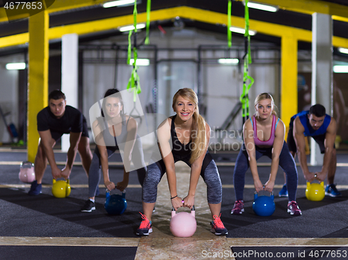 Image of athletes doing exercises with kettlebells