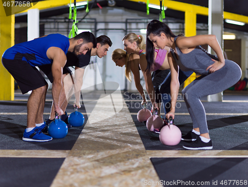 Image of athletes doing exercises with kettlebells