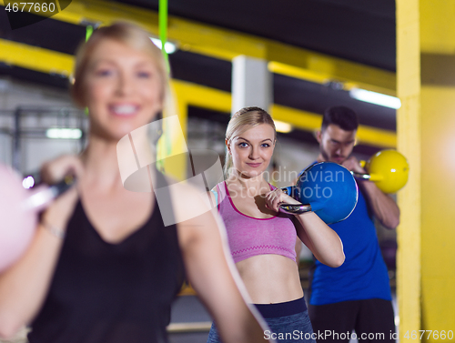 Image of athletes doing exercises with kettlebells