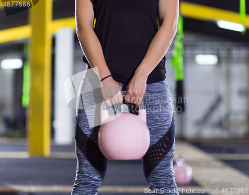 Image of woman exercise with fitness kettlebell