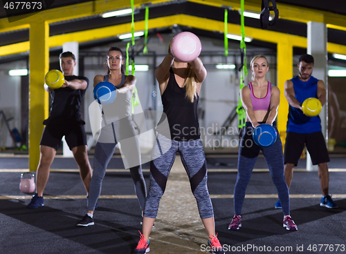 Image of athletes doing exercises with kettlebells