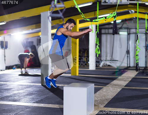 Image of man working out jumping on fit box