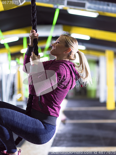 Image of woman doing rope climbing