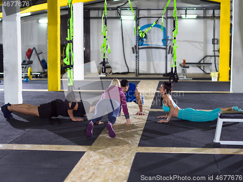 Image of young healthy people doing pushups